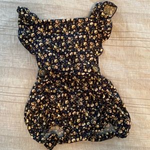 12 month romper. Navy with tan floral pattern. Adjustable straps.